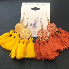 Introducing a stunning pair of quadruple tassel earrings that will add the perfect touch of flair to your accessory collection. These earrings are designed with four vibrant tassels suspended elegantly from a gorgeous gold-toned accented medallion, creating a statement piece that’s both stylish and playful. Whether you’re looking to elevate your casual look or add a fun twist to your evening wear, these earrings are sure to impress. This set comes with two color options, allowing you to switch u Adjustable Gold Tassel Earrings With Fringe, Adjustable Gold Bohemian Tassel Earrings, Bohemian Gold Tassel Earrings With Fringe, Gold Bohemian Tassel Earrings With Fringe, Adjustable Orange Tassel Earrings, Orange Tassel Earrings, Tassel Earring, Bold Accessories, Neutral Outfit