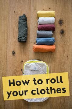 a pile of clothes sitting on top of a wooden floor next to a yellow sign