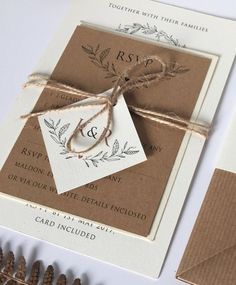 the wedding stationery is tied up with twine