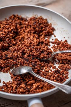 a pan filled with granola sitting on top of a wooden table