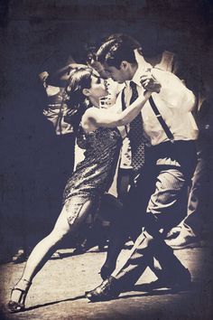 a man and woman dancing on the street