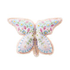 a butterfly shaped pillow with flowers on it