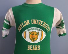 "Vintage 1970s-1980s green, yellow, and white Baylor University Bears t-shirt. Size: Small Brand: Artex 75% cotton, 25% nylon The shirt is soft and in very good vintage condition, with no stains - though holes on both shoulder sides of the collar and 2 snags on back below collar. Approximate measurements with garment laying flat (INCHES): Length (from top of shoulder at collar seam to bottom) : 25.5\" Sleeve (from top of shoulder seam to cuff edge) : 10\" Between Shoulder Seams : 15\" Underarm t Baylor University, College T Shirts, Bear T Shirt, 80s Vintage, College Outfits, Cool Tees, Vintage Tshirts, Ncaa, Bears