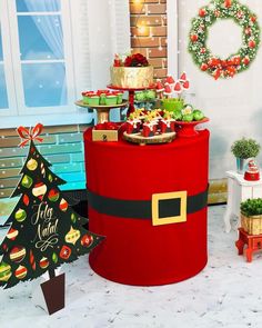 there is a large red santa claus hat on the table with other holiday foods and decorations around it