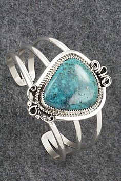 This stunning turquoise and sterling silver bracelet was made by Navajo silversmith Leslie Nez. The back is signed Leslie Nez and Sterling.Size: 5 5/8" (will fit up to a 6 3/4" wrist)Gap: 1 1/8"Length: 2"Width: 1 1/2"Free shipping on all orders! We ship with USPS and always include tracking. All orders ship within a day of payment.Returns are accepted up to 30 days after you receive your order. Just send us a message. Our shop offers cash back or store credit. The item must be returned in new co Unique Turquoise Sterling Silver Bracelets, Elegant Sterling Silver Bracelet With Turquoise, Artisan Turquoise Sterling Silver Bracelet, Untreated Sterling Silver Bracelet, Adjustable Southwestern Sterling Silver Bracelet With Turquoise, Adjustable Southwestern Turquoise Sterling Silver Bracelet, Bohemian Turquoise Sterling Silver Cuff Bracelet, Collectible Bohemian Blue Sterling Silver Bracelet, Turquoise Sterling Silver Cuff Bracelet With Polished Finish