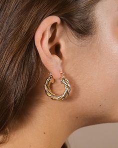 Experience the sophistication and style of Esme Braided Hoops. Crafted with a textured finish and designed to be worn as an everyday accessory, these hoops reintroduce luxury to your everyday wardrobe. Wear with confidence, knowing you're making a statement with your accessories. Material: 14K gold or rhodium plated brass Features: 1.15" hoop, 0.2" width, Lead & Nickel free, friction latch Chic Textured Gold Earrings, Textured Metal Hoop Earrings For Gift, Textured Small Hoop Metal Jewelry, Textured Metal Drop Earrings, Elegant Textured Round Jewelry, Chic Textured Metal Earrings, Elegant Textured Metal Earrings, Everyday Small Hoop Textured Earrings, Modern Textured Small Hoop Earrings