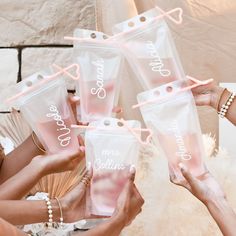 four women holding up pink personalized bags