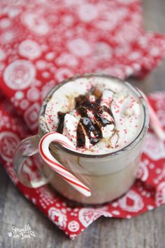 a hot chocolate drink with marshmallows and candy cane