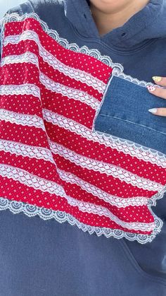 a woman holding an american flag scarf in her pocket with lace on the bottom and sides