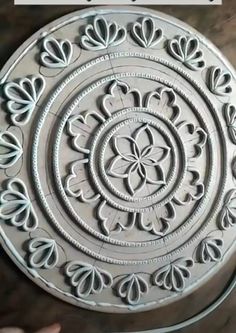 a metal plate with an ornate design on it