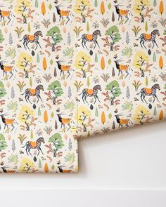 a close up of a wallpaper with horses and trees on it, as well as an image of the fabric