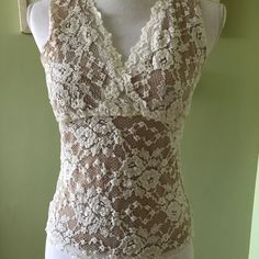 Beautiful Nude Illusion Cabi Lace Tank. Never Worn - No Stains Or Flaws! Beige Fitted Lace Tank Top, Sleeveless Stretch Lace Top, Elegant Sheer Sleeveless Camisole, Sleeveless Sheer Lace Tops, Feminine Sleeveless Stretch Lace Top, Feminine Stretch Sleeveless Lace Top, Fitted Sleeveless Lace Blouse, Fitted Sleeveless Lace Top, Chic Fitted Sleeveless Lace Blouse