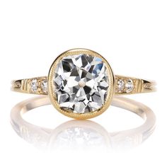 a yellow gold ring with an oval cut diamond in the center