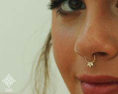 a close up of a woman's nose and nose piercing