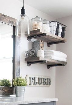 the bathroom is decorated in white and gray with shelves on the wall above the sink