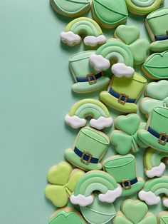 green and white decorated cookies on a blue surface with shamrocks, hats and clovers