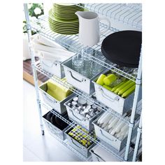 the shelves are organized with plastic containers, plates and utensils to keep food fresh