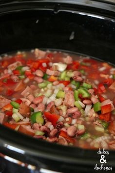 a crock pot filled with meat and vegetables