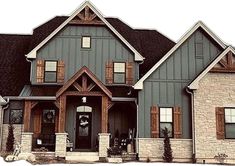 a large gray house with two story windows