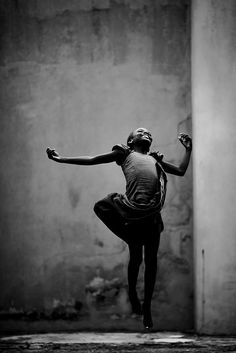 a black and white photo of a woman dancing