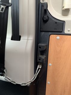 the interior of a vehicle with a chain attached to the front door and side doors