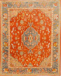 an orange and blue rug with floral designs