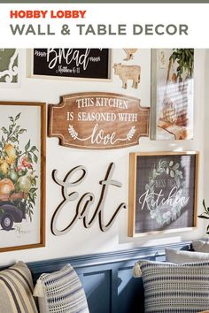 the kitchen wall is decorated with wood signs and framed pictures, along with other decorative items