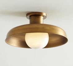 a close up of a light fixture on a ceiling with a white wall in the background