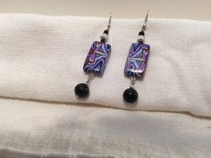 These unique earrings will look great separately, or as part of a set. Artistic Black Jewelry With Matching Earrings, Artsy Purple Dangle Earrings, Artsy Drop Earrings For Party, Artsy Black Drop Earrings, Artsy Black Dangle Earrings, Handmade Rectangular Earrings For Parties, Elegant Multicolor Plug Earrings For Gift, Purple Abstract, Unique Earrings