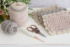 some yarn and scissors are sitting on a table