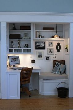 a home office with built in desk and shelves