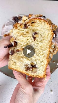 someone holding a piece of bread with raisins on it