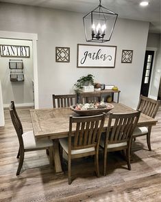 a dining room table with chairs and a bowl of fruit on top of it in front of a doorway