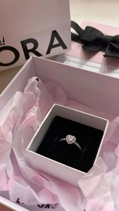 an open box with a ring in it