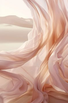 an abstract photo with flowing fabric in pink and beige colors on a white background that is very soft