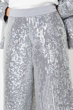 Dazzling sequin-embellished wide-leg trousers that radiate glamour Flattering high-waisted design for an elongated silhouette Lightweight and breathable fabric for all-night comfort Fully lined for a smooth, polished finish Concealed side zip fastening for a sleek appearance Exude sophistication and elegance in these shimmering wide-leg trousers from Coast. Perfect for formal occasions like weddings, races, or graduations, these trousers will make you the centre of attention. Style them with a tailored blazer and heels for a refined, polished look that conveys effortless luxury. Alternatively, pair them with a silk camisole and statement jewellery for a glamorous evening ensemble that radiates confidence and style. Bridal Jumpsuit, Wedding Jumpsuit, Silk Camisole, Statement Jewellery, Feather Dress, Puff Sleeve Dresses, Tailored Blazer, Halterneck Dress, Bridal Wedding Dresses