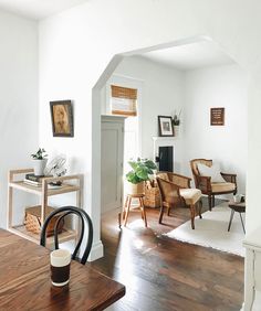 a living room with white walls and wooden floors