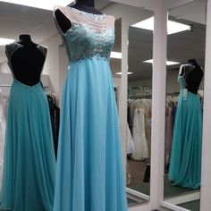 Elegant 2cute Gown With Intricately Beaded Bodice And Open Back Style 51132 Color: Turquoise Size: 2 Light Blue Embellished Dress For Prom Season, Light Blue Embellished Evening Dress For Prom, Embellished Light Blue Evening Dress For Prom, Light Blue Embellished Gown For Prom Season, Light Blue Embellished Gown For Prom, Embellished Blue Gown For Debutante Ball, Blue Lace Bodice Gown For Debutante Ball, Blue Lace Bodice Evening Dress For Prom, Blue Gown With Lace Bodice For Debutante Ball