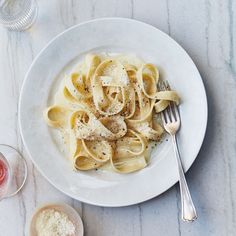 a white plate topped with pasta and sauce