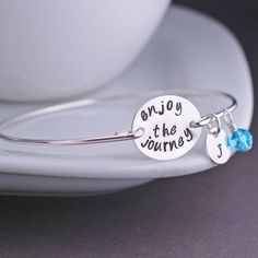 Enjoy the Journey Bangle Bracelet Graduation by georgiedesigns Inspirational Adjustable Jewelry With Engraving Option, Inspirational Engraved Bangle Bracelets, Inspirational Engraved Bangle Bracelet, Spiritual Hand Stamped Silver Bracelets, Inspirational Engraved Bracelet Jewelry, Inspirational Hand Stamped Jewelry Bracelet, Inspirational Hand Stamped Bracelet Jewelry, Hand Stamped Meaningful Bracelet For Anniversary, Inspirational Stackable Friendship Jewelry