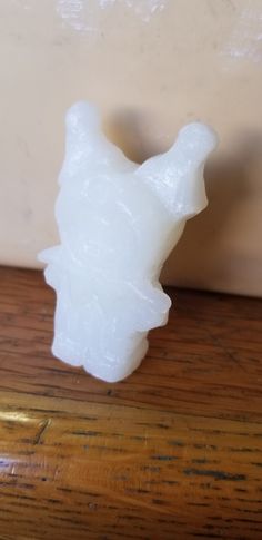 a white object sitting on top of a wooden table