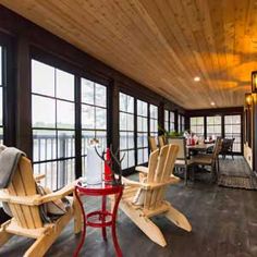 a porch with chairs and tables on it