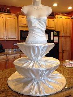 a mannequin made out of white satin material on a countertop in a kitchen