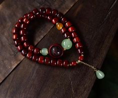 Small Leaf Red Sandalwood Two Loop Bracelet with Small Leaf Carved Beads and Jade Chalcedony Beads Material: Sandalwood beads, stone, rope. Red Jade Bracelet, Red Sandalwood, Red Jade, Circle Bracelet, Small Leaf, Jade Bracelet, Beaded Material, Thoughtful Gifts, Jade