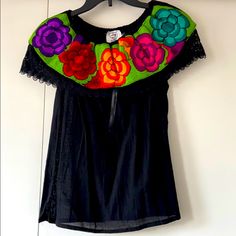 Mexican Floral Embroidered Off The Shoulder Top; Never Worn Black Embroidered Summer Blouse, Fitted Black Embroidered Top For Festival, Black Embroidered Top For Summer Festival, Traditional Black Embroidered Top For Spring, Black Folk Style Summer Blouse, Folk Style Black Blouse For Summer, Black Embroidered Neckline Top For Summer, Black Embroidered Top With Neckline Detail For Summer, Festival Black Top With Embroidered Neckline