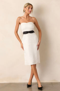 Elevate your style with our Whispers Of Paris Ivory Jacquard Strapless Midi Dress. Crafted with intricate jacquard fabric, this dress exudes elegance and sophistication. The strapless design adds a touch of glamour, while the midi length creates a flattering silhouette. Perfect for any occasion, this dress will make you feel confident and chic. This dress features a sweetheart neckline, a black waist belt with a bow, a discrete back zipper, a small slit in the back hem and a strapless design. Black Waist Belt, Halter Bridesmaid Dress, Strapless Midi Dress, Red Midi Dress, Black Dresses Casual, Little White Dresses, Jacquard Fabric, Event Dresses, Classy Dress