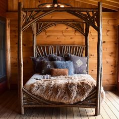 a bed made out of branches with pillows on it