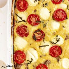 a casserole dish with tomatoes, mozzarella and cheese on top is ready to be eaten