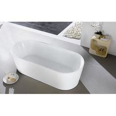 a white bath tub sitting on top of a tiled floor