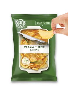 a bag of cream cheese chips being held up by a person's hand over the top of it